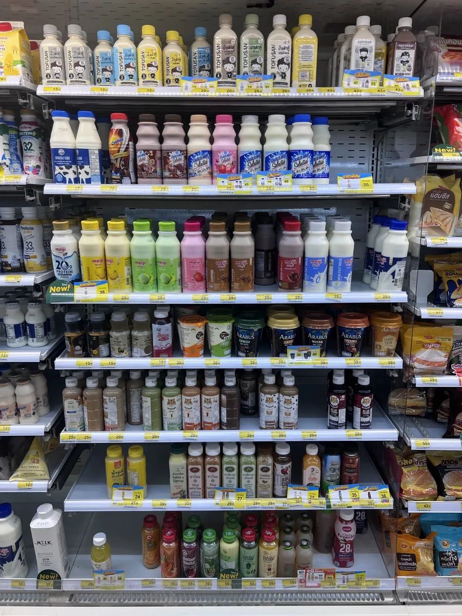 Chilled milk and drink aisle in a Thai 7-Eleven with Meiji high-protein milks